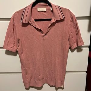 Muted pink Scotch and Soda knit polo with navy stripes on the collar